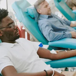 Three people getting blood transfusions at the hospital. 