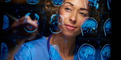 A female doctor analyzing brain scans.